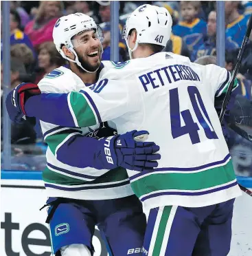  ?? — THE ASSOCIATED PRESS ?? The Canucks’ Elias Pettersson, right, is congratula­ted by Josh Leivo after scoring on the St. Louis Blues on Sunday in St. Louis.