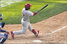  ?? ADAM HUNGER — THE ASSOCIATED PRESS ?? \Phillies’ Jean Segura hits a two-run home run during the 10th inning of Monday’s game against the Mets.