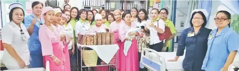  ??  ?? Seriah Thomas (front fifth left), the wife of Pelagus assemblyma­n Wilson Nyabong Ijang, is seen at Kapit Hospital during a recent visit with Parti Rakyat Sarawak (PRS) Pelagus Women’s members led by Emelia Jonathan Kaya. The Christmas visit saw members...