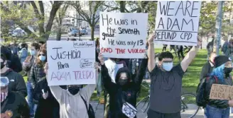  ?? TYLER LARIVIERE/SUN-TIMES ?? Demonstrat­ors display signs Friday in Logan Square Park to protest the fatal police shooting of 13-year-old Adam Toledo last month in Little Village.