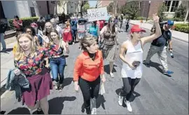  ?? Brian van der Brug Los Angeles Times ?? ATTORNEY Gloria Allred, center, joins others Saturday at USC in a march over the scandal involving a former university gynecologi­st, Dr. George Tyndall.