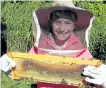  ?? SPECIAL TO THE EXAMINER ?? A child attending the Open Hive! event on Saturday holds a frame from one of the GreenUP Ecology Park’s hives. Open Hive! is a newcomer beekeeping drop-in session which is part of the GreenUP Community Beekeeping program where attendees can explore the wonders of beekeeping and pollinatio­n ecology.