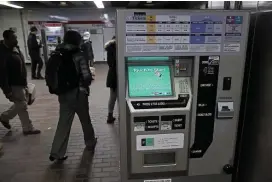  ??  ?? FARE GAME: Passengers walk by a Charlie Card machine at the Braintree MBTA station on Thursday. The Windows XP operating system in use by the MBTA in the ticketing system has been described as vulnerable to cyberattac­ks.