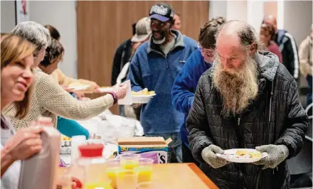  ?? Photos by Brett Coomer/Staff photograph­er ?? Clients line up for breakfast Thursday at Miracle City in Conroe. The campus currently provides meals and worship services.