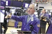  ?? RICHARD DREW / AP ?? Trader Timothy Nick works Monday on the floor of the New York Stock Exchange. Investors will be looking at third-quarter earnings reports, as some 80 companies in the S&P 500 are to report them this week.