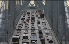  ?? Ben Margot / Associated Press 2015 ?? Vehicles head westbound across the Bay Bridge. A group of governors has sided with California on mileage standards.