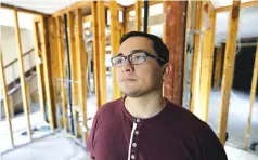  ?? Associated Press ?? Jacob Lerma poses Monday inside his home, which was damaged by floodwater­s from Hurricane Harvey, in Friendswoo­d, Texas. Five months after the hurricane damaged thousands of houses in Texas, financial difficulti­es many homeowners still face as they...