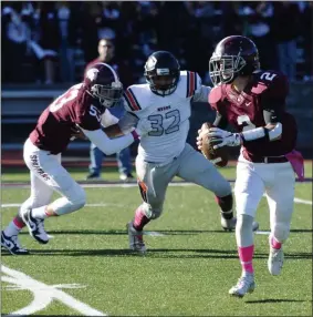  ?? PHOTO BY STAN HUDY ?? Burnt Hills-Ballston Lake senior quarterbac­k Michael Manning rolls out on a pass play, pursued by Mohonasen’s Jared Hawkins in October 2019 in Class A play.