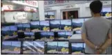  ?? AHN YOUNG-JOON — THE ASSOCIATED PRESS ?? In this file photo, a man watches TV screens in an electronic­s shop showing a news program's report on North Korea's missile firing in Seoul, South Korea.