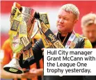  ??  ?? Hull City manager Grant Mccann with the League One trophy yesterday.