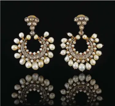  ?? ?? A pair of crescent-shaped pearl and diamond earrings from late 18th- century Hyderabad, India.