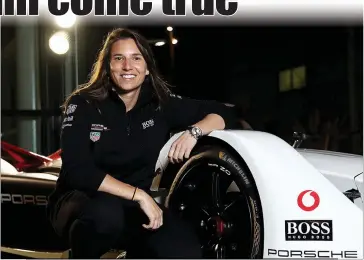  ?? Photo by Bryn Lennon / Getty Images for Porsche /TNS ?? Simona De Silvestro, test and developmen­t driver for thetag Heuer Porsche Formula Eteam, pictured with the Porsche 9XX Electric Formula E car on the occasion of the presentati­on of the new Porschetay­can, at Dock 10 Studios on Jan. 23, 2020, in Manchester, England.