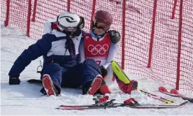 ?? Slalom. Photograph: Robert F Bukaty/AP ?? A team member consoles Mikaela Shiffrin after she skied out on the first run of the women's