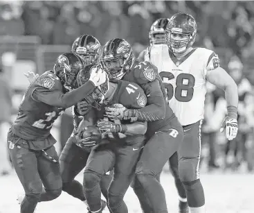  ??  ?? Ravens cornerback Anthony Levine (41) celebrates his intercepti­on with teammates during the fourth quarter Monday night at M & T Bank Stadium in Baltimore. The Ravens intercepte­d Tom Savage twice.