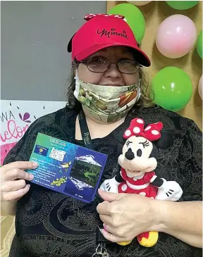  ?? Submitted photo ?? Kimberly, a resident at The Retreat at Kenwood, poses with her gifts and a postcard from her pen pal in Oregon.