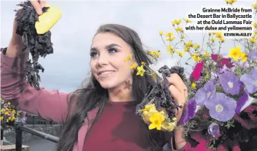  ?? KEVIN McAULEY ?? Grainne McBride from the Desert Bar in Ballycastl­eat the Ould Lammas Fair with her dulse and yellowman