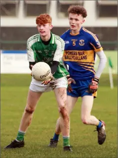  ??  ?? Evan O’Dwyer of Naomh Eanna handpasses the ball away from Gusserane defender Eoin Codd.