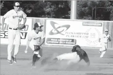  ?? Herald photo by Greg Bobinec ?? Bryce Oriold-Fraser from the Lethbridge Bulls forces out Kaiden Cardoso from the Vauxhall Jets at second base Wednesday night at the Tanner Craswell and Mitch Maclean Benefit Game to raise money for baseball scholarshi­ps for the Bulls.