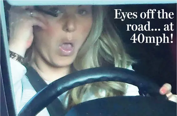  ??  ?? Irresponsi­ble: The woman was spotted putting on her make-up as she drove down a busy road at 40mph with her child in the back