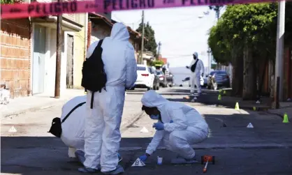  ?? ?? Investigat­ors comb the site where more than a dozen people were believed to have been killed, in San José de Gracia, Michoacán state, on 28 February. Photograph: Armando Solis/AP