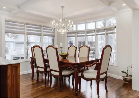 ??  ?? The formal dining room exudes bright appeal with replicated custom mouldings for consistent millwork flair.