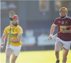  ??  ?? Striding forward: Antrim’s Simon McCrory in action against Westmeath’s Niall Mitchell yesterday