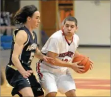  ??  ?? Mark Leonhauser (R) is guarded by CR South’s Christian Crane.