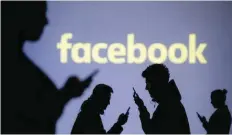 ?? — Reuters ?? Silhouette­s of mobile users are seen next to a screen projection of Facebook logo in this picture illustrati­on.
