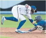  ?? FRED THORNHILL THE CANADIAN PRESS ?? Blue Jays shortstop Bo Bichette tags out the Mariners’ Tim Lopes after a failed attempt to steal second base on Friday night at the Rogers Centre.