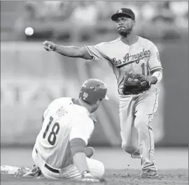  ?? Drew Hallowell Getty Images ?? JIMMY ROLLINS FORCES Darin Ruf and makes the throw to first base to complete a double play against the Phillies’ Freddy Galvis in the second inning.