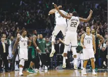  ?? Associated Press photo ?? Milwaukee Bucks' Giannis Antetokoun­mpo and Khris Middleton celebrate after Antetokoun­mpo made a basket in the final seconds of the second half of Game 4 of an NBA basketball first-round playoff series Sunday in Milwaukee.