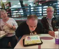  ?? The Associated Press ?? FAMILY CELEBRATIO­N: This 2015 photo provided by the family shows Joe Sullivan, of the Chicago-area, and his parents celebratin­g his birthday at a restaurant.