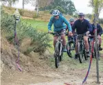  ?? PHOTO: RUBY
HEYWARD ?? Wheely good track . . . Kelvin Benny (15) leads a group of pupils who christened the new mountain bike track at St Kevin’s College on Saturday.