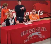  ?? David Jacobs/sdg Newspapers ?? Shelby High School senior Tanner Hartz signs on April 12 to play football with Heidelberg University as his parents, Beth and Marc Hartz, and brothers Conner Hartz and Zack Hartz, watch.