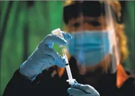  ?? Gary Coronado Los Angeles Times ?? REGISTERED NURSE Ruth Ann Rowan, Tehama County Healthcare Coalition coordinato­r, prepares a Moderna COVID-19 vaccinatio­n in Corning, Calif.