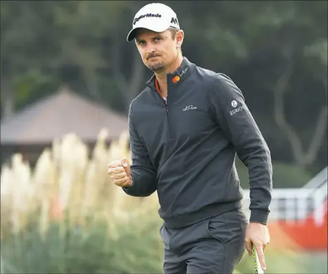  ?? Ross Kinnaird/Getty Images ?? Justin Rose celebrates on the 18th green after finishing 14 under to win the HSBC Champions tournament in Shanghai.