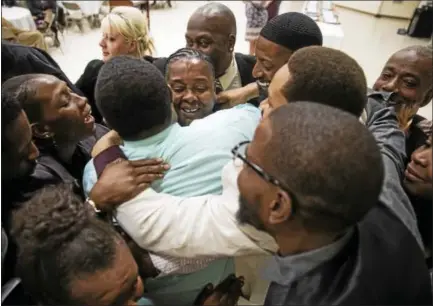  ?? MATT ROURKE — THE ASSOCIATED PRESS ?? Paulette Carrington, center, a participan­t in Uplift Solutions’ job training program for former inmates, is embraced by her classmates during a graduation ceremony in Philadelph­ia, Monday, Oct. 16, 2017. The release of dozens of former juvenile lifers,...