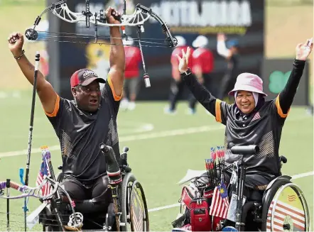  ??  ?? Jubilation: Malaysian archers Nor Sa’adah Abdul Wahab (right) and K. Morogen (left) celebrate after winning the compound gold medal in the para-archery mixed team match final at the 9th Asean Para Games in 2017.