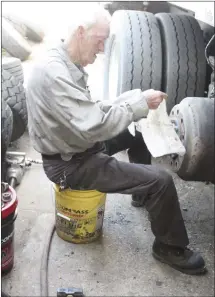  ?? Katie West • Times-Herald ?? Charles Holland works on a garbage truck at the Forrest City Public Works building. The department will soon began striping roads that were repaired during the cape sealing project.