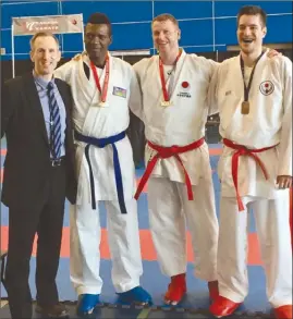  ?? Photo contribute­d ?? Richard Mosdell (event organizer), from left, Djida Abdoulaye, Paul Atkin (owner and head instructor of Kelowna Karate & Fitness) and Curtis Mayes pose together at the recent Canada Open Karate Championsh­ips in Richmond.