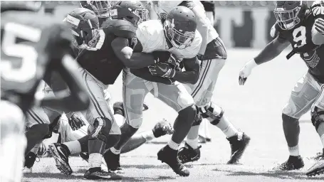  ?? KENT GIDLEY/ALABAMA PHOTO ?? Alabama tailback Bo Scarbrough runs against Tide defenders during Saturday’s first scrimmage of the preseason inside Bryant-Denny Stadium.