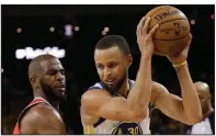  ?? AP/MARCIO JOSE SANCHEZ ?? Golden State Warriors guard Stephen Curry (right) is guarded by Houston Rockets guard Chris Paul during the second half of Game 3 of the Western Conference finals Sunday in Oakland, Calif. Curry scored 35 points to lead the Warriors to a 126-85 victory...