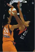  ?? CHRIS O’MEARA — THE ASSOCIATED PRESS ?? Las Vegas Aces star A’ja Wilson defends Connecticu­t Sun forward DeWanna Bonner in Tuesday’s WNBA game.