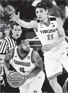  ?? WILFREDO LEE/AP ?? Virginia’s Ty Jerome, right, defends UNC Wilmington guard Jordon Talley.