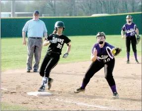  ?? MARK HUMPHREY ENTERPRISE-LEADER ?? Opposite No. 30s. Prairie Grove junior Madison Vinson arrives safely on base while Elkins third baseman Lakyn Whelpey receives a throw. The Lady Tigers won by a 13-3 run-rule score at home March 28.
