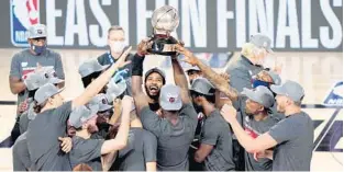  ?? MARKJ.TERRILL/AP ?? The Miami Heat celebrate winning the Eastern Conference finals.