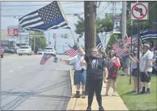  ??  ?? Delaney George of Glenolden holds a police flag at the ‘Back the Blue’ rally in Ridley Sunday. “I’m just trying to show my support for the police,” George said.