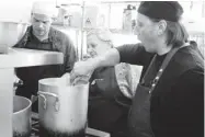  ??  ?? Vézina stirs the pot with Bélanger, centre, and Jolivet. Once a menu is chosen, assignment­s are divvied up.