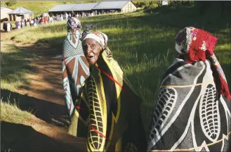  ?? Associated Press photos ?? In this Feb. 17, 2007 file photo, Lesotho women draped in blankets walk towards a polling station in the village of Machache. The blockbuste­r film “Black Panther” has created a new compelling vision of Africa as a continent of smart, technologi­cally...