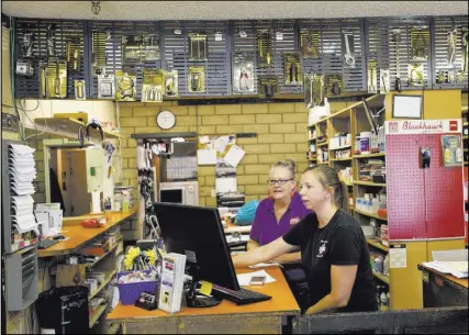  ??  ?? Pam Shivley, left, and Katie Minucci work Wednesday at Auto Specialist­s, a business on Juniper Way.